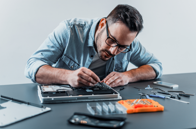 A man repairing a computer